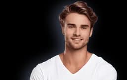 Portrait of a young man aged 25-35 with brown hair wearing a white t-shirt